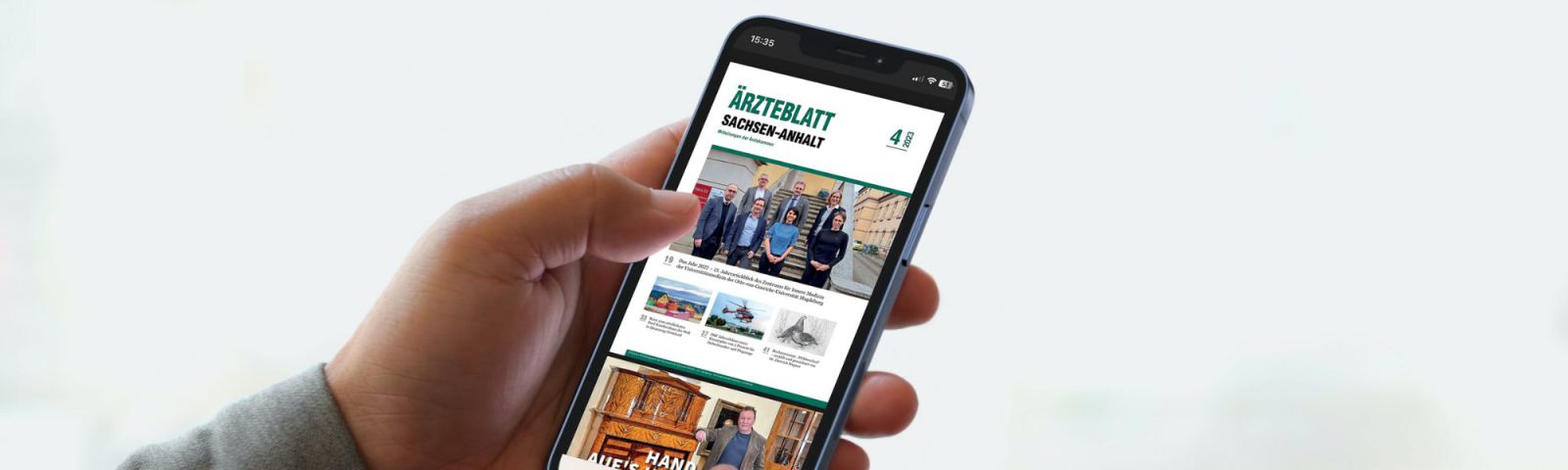 Hand hält Smartphone mit geöffneter Ausgabe des Ärzteblatts Sachsen-Anhalt auf dem Display